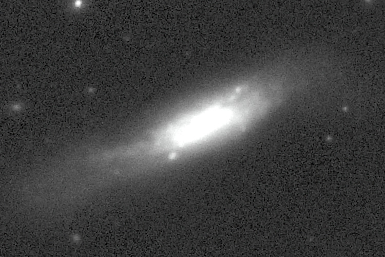 black and white image of supernova in distant galaxy