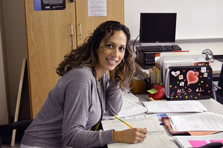 woman writing at desk