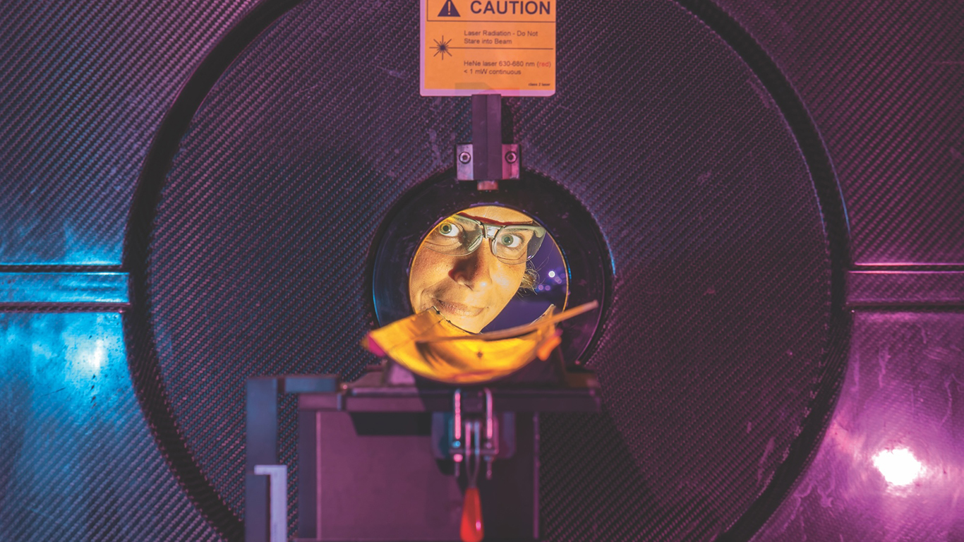 Professor Rebecca Abergel peers through a positron emission tomography (PET) scanner at Berkeley Lab.