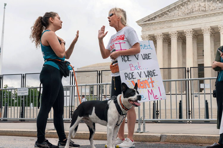 two women outside the U.S. Supreme Court argue about abortion rights, one of the most divisive issues in contemporary politics