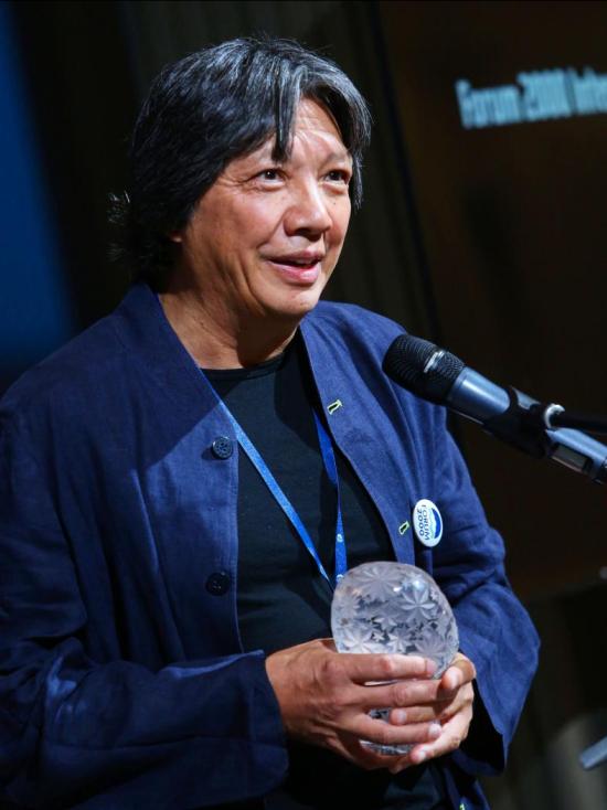 shot of someone talking into a mic holding a waterbottle