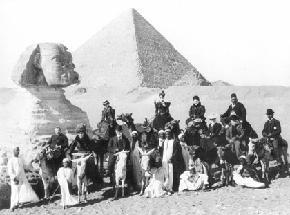 black and white photo of archeologists posing next to the sphinx of Egypt.