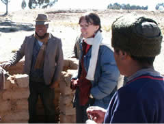 Hastorf speaks with two men in front of a brick wall.