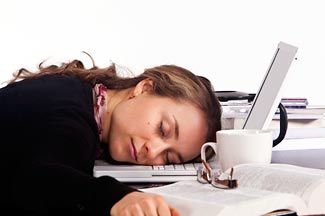 stock photo of a woman sleeping at her desk.