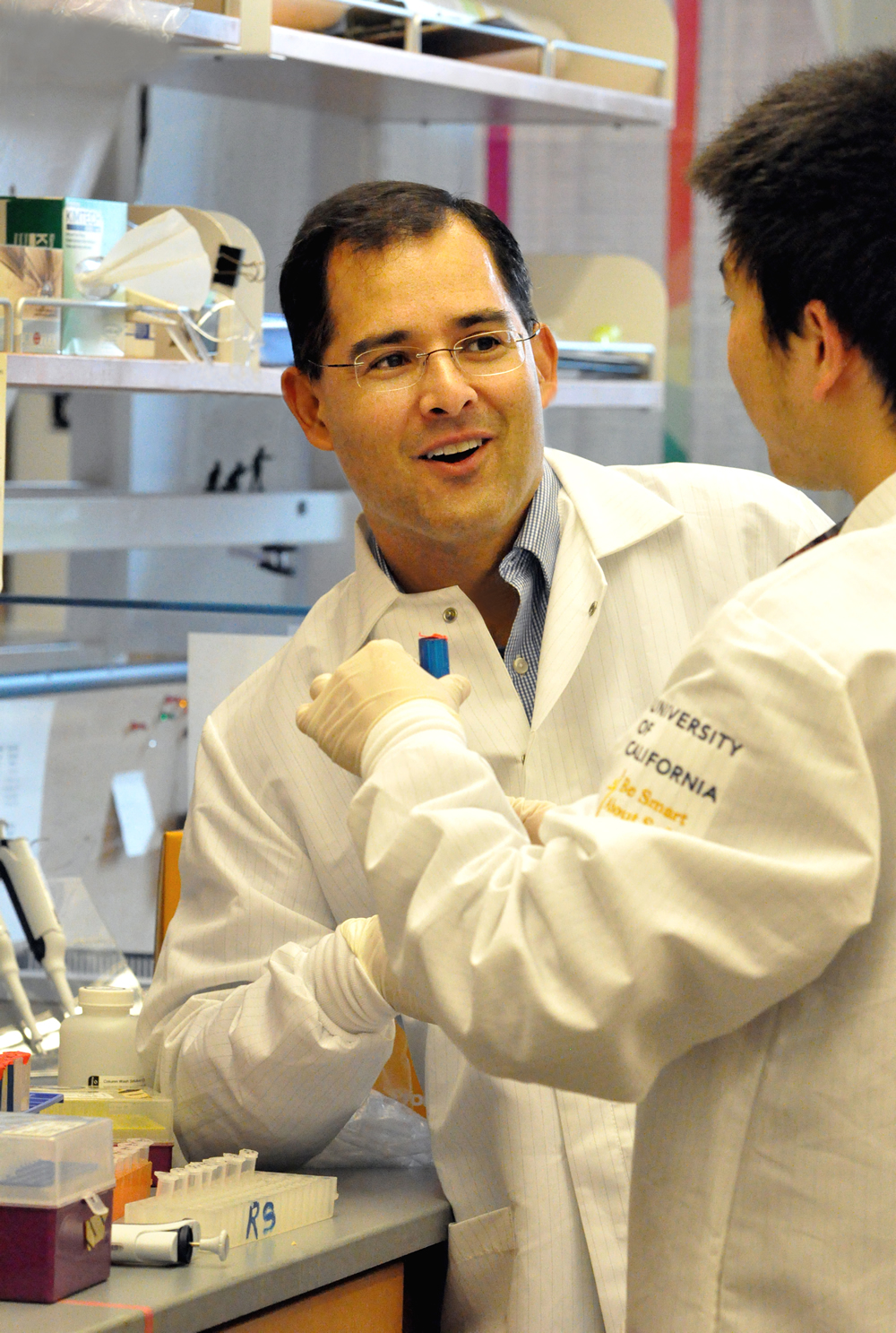 David Schaffer smiling while talking with fellow lab mate