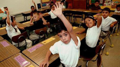 A group of students raise their hands to answer a question.