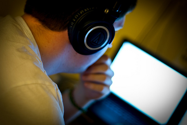 Photo of a man typing on his computer.