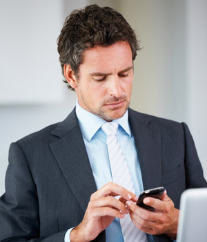 Stock photo of a man on his phone.