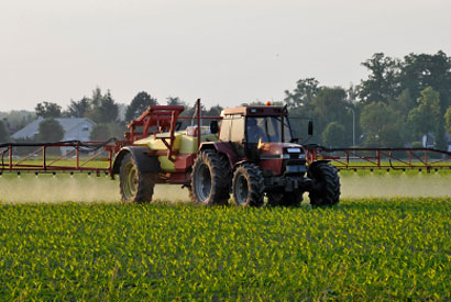 A tractor spraying pesticide.