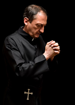 A priest prays.