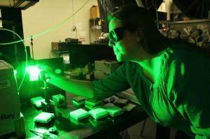 A researcher working with a low green light.