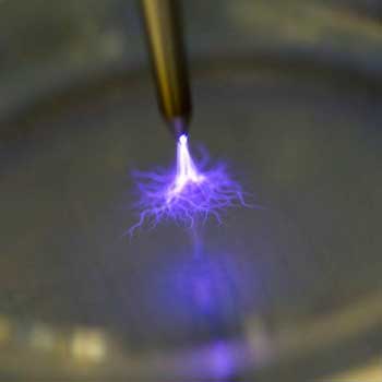 A small purple spark produced by a cylinder.