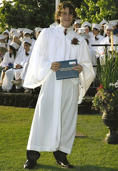 Austin Whitney presents a diploma.