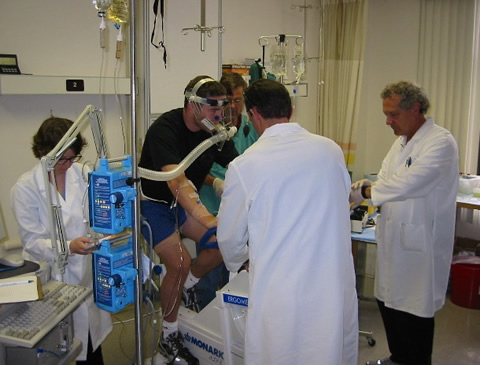 Brooks and other researchers study a patient.