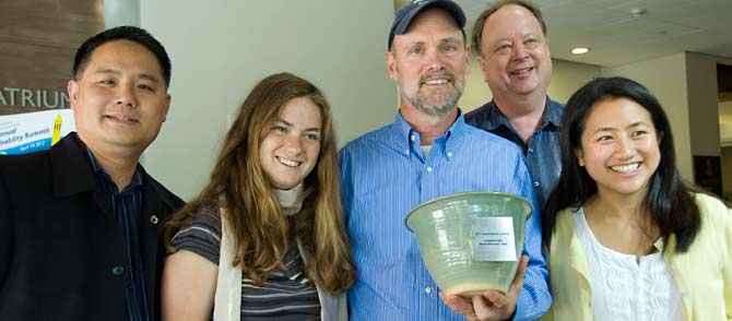 Five researchers pose with their trophy.