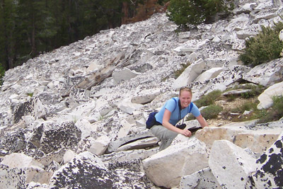 Rubidge climbs a rocky cliff.