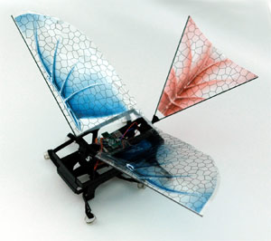 A robot with small red and blue cloth wings.