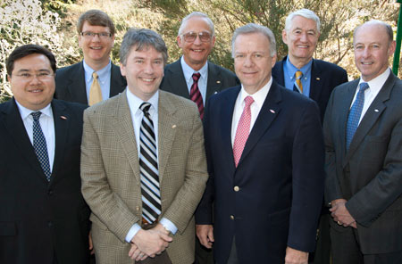 Seven men in suits.
