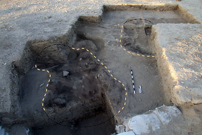 An area of excavated land with lines drawn where huts were found.