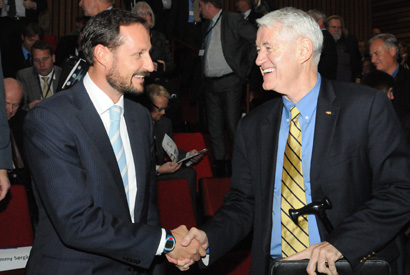 Two men shake hands.