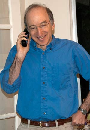 A man stands in a doorway while talking on the phone.