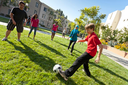 Youth playing soccer outside.