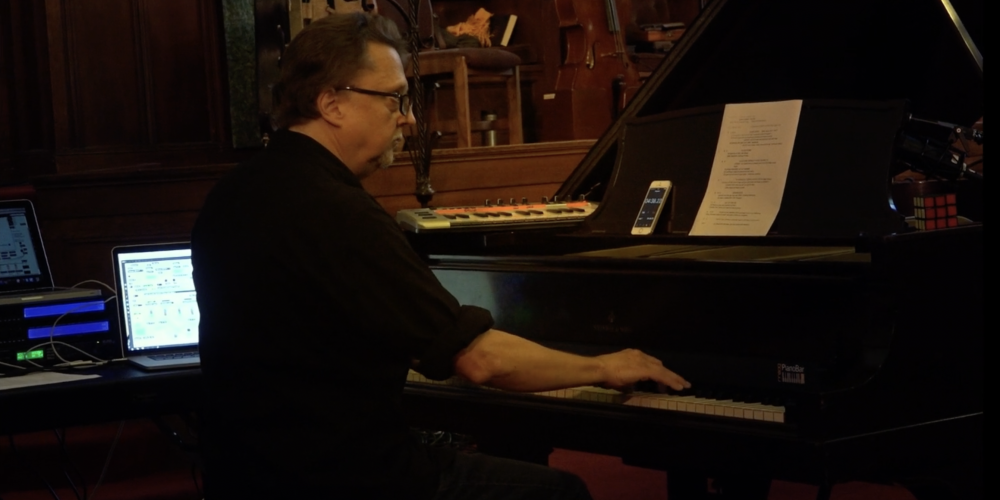 Edmund Campion sitting at a piano