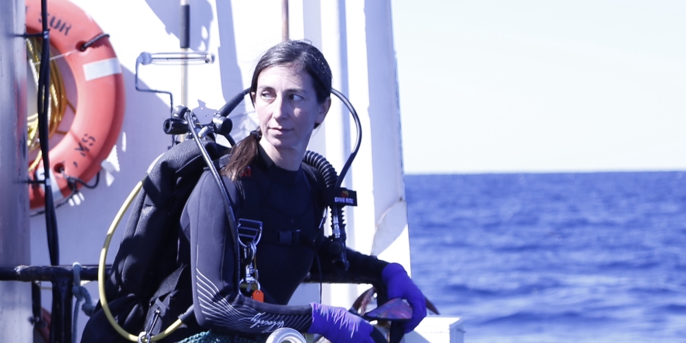 Adrienne Correa preparing to jump off a ship in order to sample coral colonies on SCUBA in the northwest Gulf of Mexico
