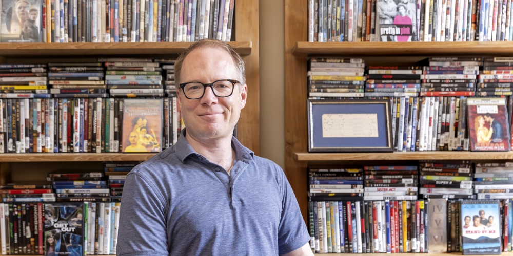 David Bamman in office setting with bookcase in background