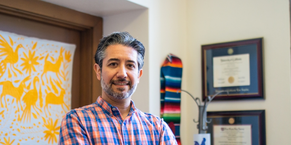 Adrian Aguilera standing in an office