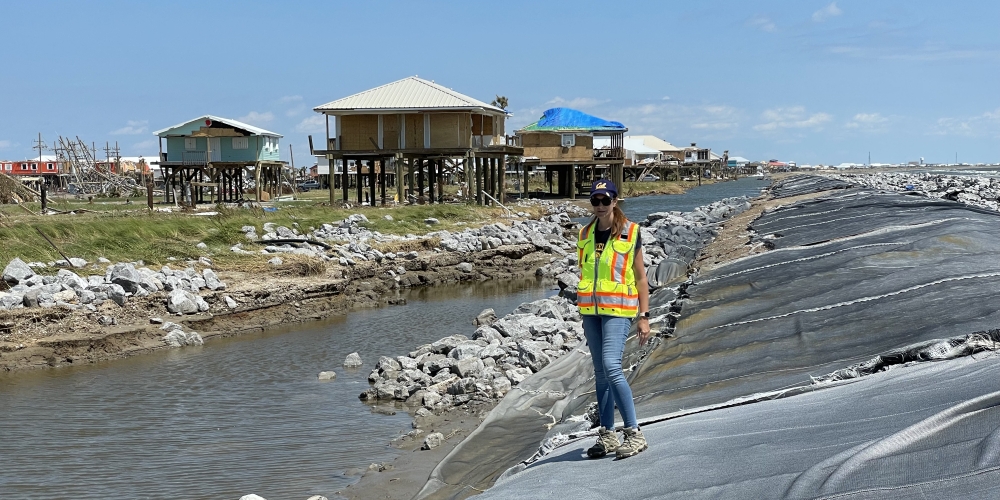 Prof. Adda Athanasopoulos-Zekkos standing on a damaged levee in Grand Isle, LA, following Hurricane Ida.