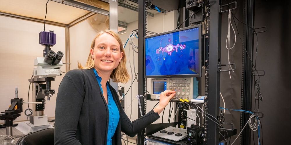 Yvette adjusting the dial on an electrophysiology rig