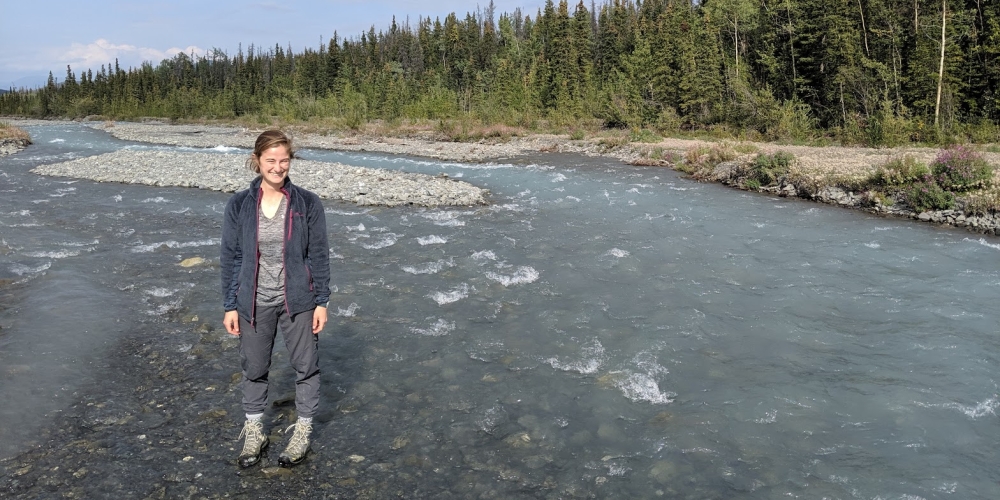 Madison Douglas standing in streambed from website