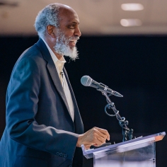 john powell at lectern 