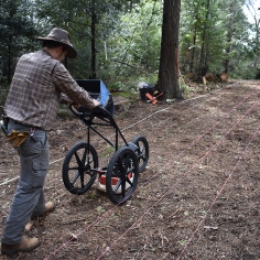 Jun Sunseri conducting ground penetrating radar survey at the request of his Community Mentors (photo courtesy of Zach Emerson of the InterTribal Ecological Restoration Crew)