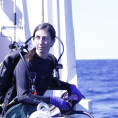 Adrienne Correa preparing to jump off a ship in order to sample coral colonies on SCUBA in the northwest Gulf of Mexico