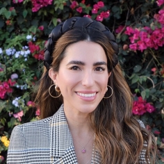 Headshot of Stephanie Canizales with flowers in the background