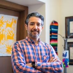 Adrian Aguilera standing in an office