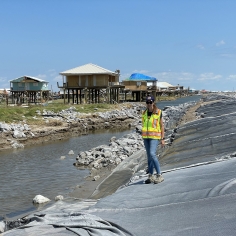 Prof. Adda Athanasopoulos-Zekkos standing on a damaged levee in Grand Isle, LA, following Hurricane Ida.