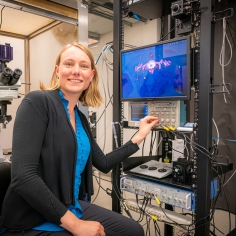 Yvette adjusting the dial on an electrophysiology rig