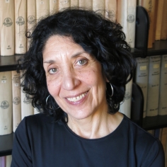 Headshot in front of bookshelves.