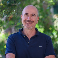 Paolo D'Odorico wearing a blue shirt, with unfocused greenery in background