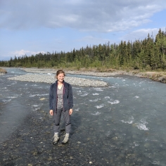 Madison Douglas standing in streambed from website
