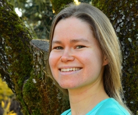 headshot of Hannah Larson with trees in background