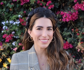 Headshot of Stephanie Canizales with flowers in the background