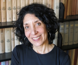 Headshot in front of bookshelves.