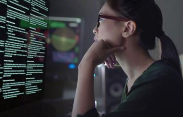 Woman looking intently at computer screen.