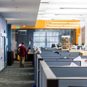 Office spaces with person walking away in background