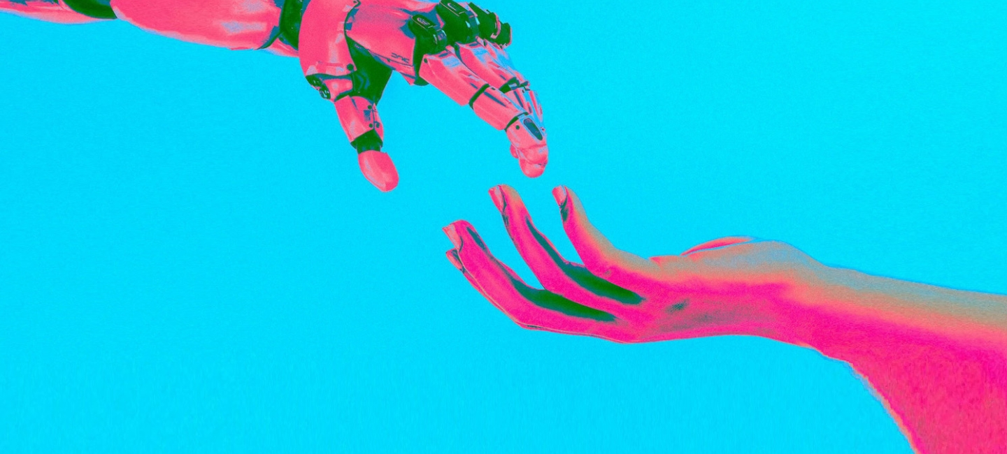 A pink robot hand and a pink human hand reach for each other against a blue background