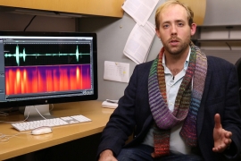Chris Holdgraf sitting next to monitor showing audio recording.